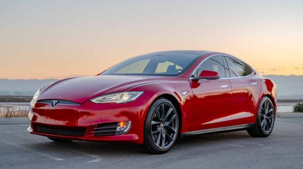 Red Tesla Model in Santa Clara receiving expert EV battery repair and replacement service at Prius and Tesla Service Center.