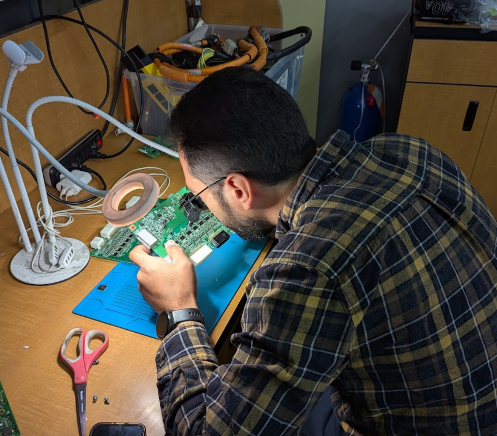 Technician inspecting electronic control chip during hybrid and EV battery service in Santa Clara